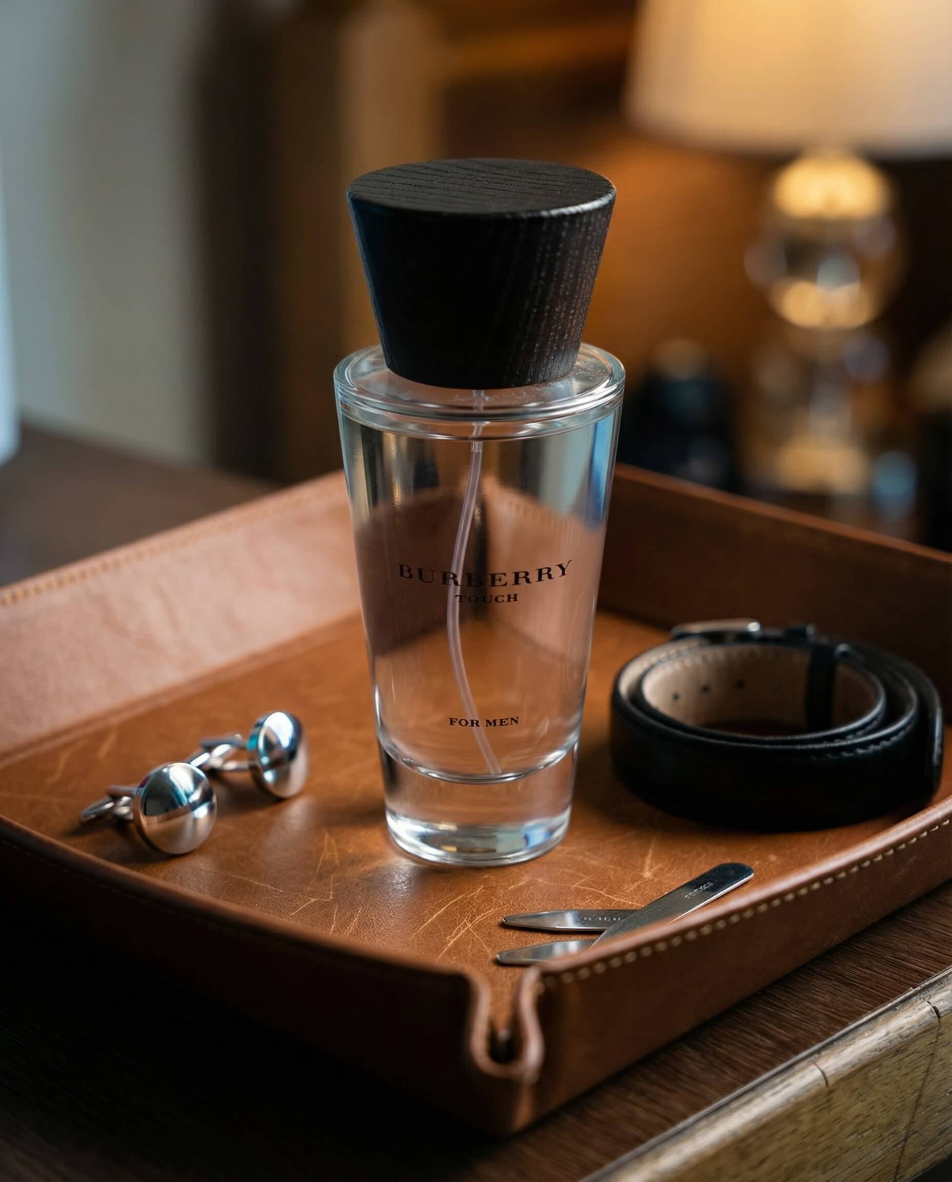 Fragrance bottle on a leather tray with grooming accessories